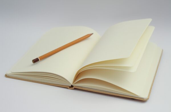 Empty notebook with a pencil on top.