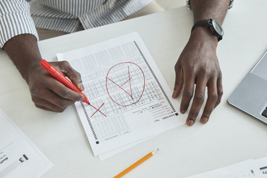 Photo by Andy Barbour: https://www.pexels.com/photo/a-person-marking-a-test-paper-6684373/